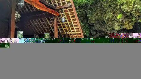 Interior Gua Maria Lawangsih Patung Bunda Maria di dalam Gua Lawangsih yang diterangi cahaya temaram